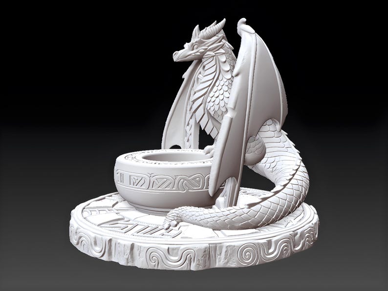 May include: A white dragon sculpture with intricate details. The dragon has large wings, a detailed body, and is perched near a decorative bowl. The sculpture sits on a round base with carved patterns, creating a fantasy-themed decorative piece.