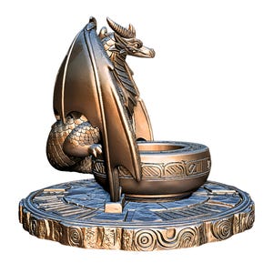 May include: Bronze dragon sculpture with detailed wings, scales, and horns. The dragon is perched on a round, ornate base with a central bowl. The sculpture has a metallic finish and is suitable for home decor.