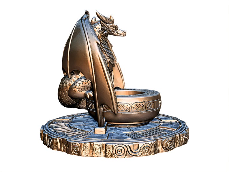 May include: Bronze dragon sculpture with detailed wings, scales, and horns. The dragon is perched on a round, ornate base with a central bowl. The sculpture has a metallic finish and is suitable for home decor.