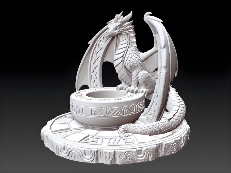 May include: A white dragon sculpture with detailed scales, horns, and wings. The dragon sits atop a round, engraved platform with a central bowl. The sculpture is a fantasy-themed decorative item.
