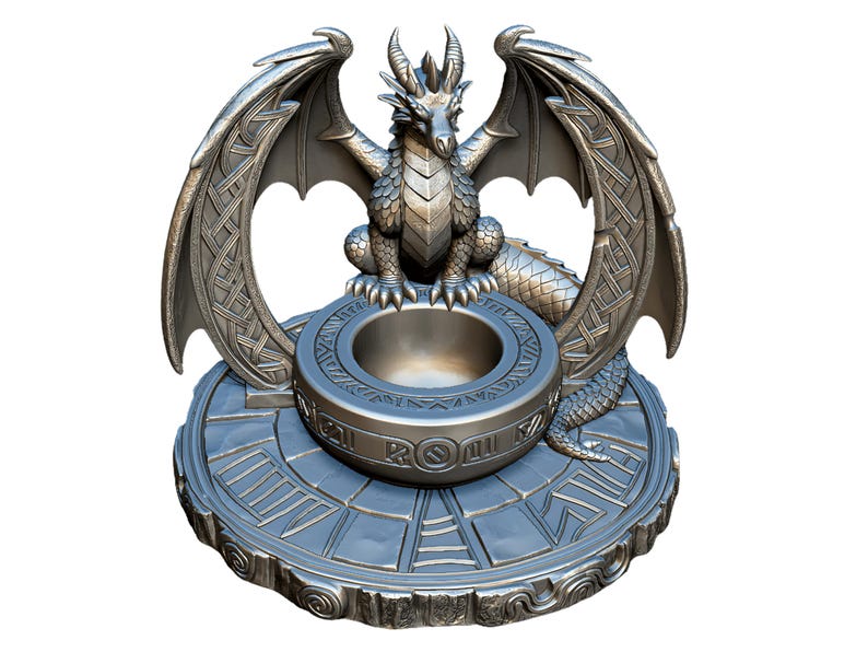 May include: A silver-colored dragon sculpture with outstretched wings, perched above a circular bowl. The dragon has detailed scales and horns. The base features a circular design with engraved patterns, creating a fantasy theme.