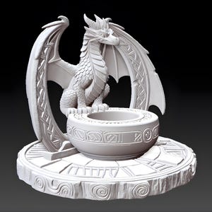 May include: A white dragon sculpture with intricate details. The dragon sits atop a round base with a bowl in front. The wings are spread, and the sculpture has a fantasy theme.
