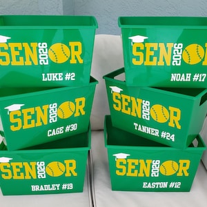 May include: A set of three ceramic mugs with a speckled, matte finish. The mugs are in shades of blue, green, and white. Each mug has a simple, modern design, perfect for coffee or tea.