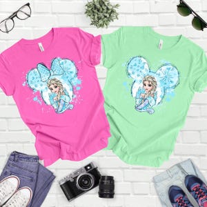 a couple of shirts sitting on top of a white brick wall