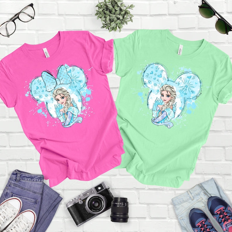 a couple of shirts sitting on top of a white brick wall