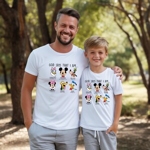 a man standing next to a little boy wearing mickey mouse shirts