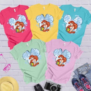 a group of four t - shirts with the little mermaid on them