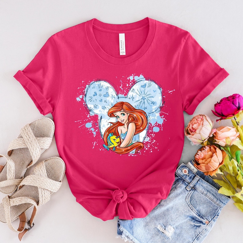 a pink shirt with a picture of a mermaid on it