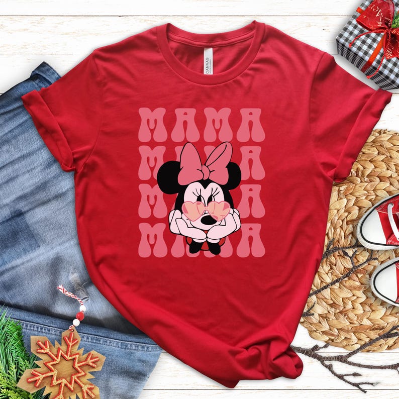 a red t-shirt with a Minnie Mouse graphic, a pair of jeans, a pair of red and white sneakers, and some Christmas decorations.