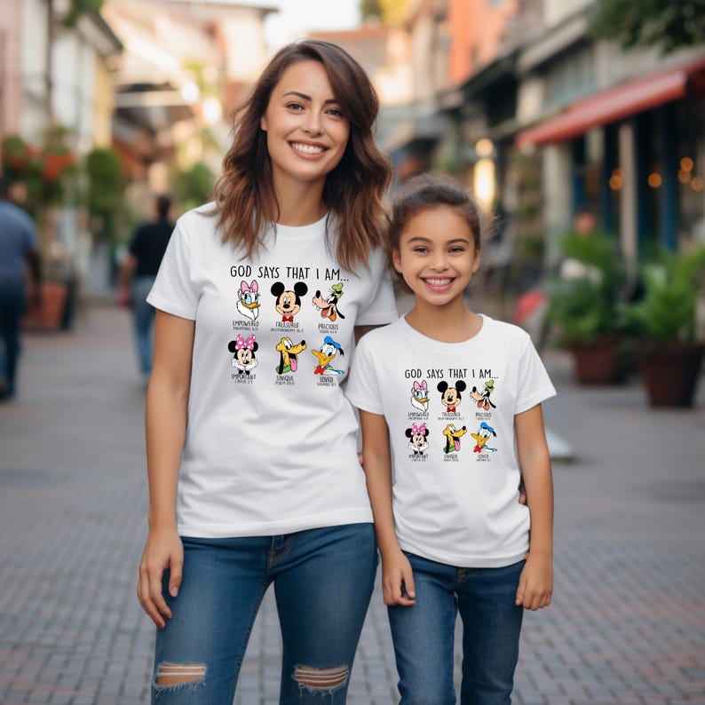 a woman standing next to a little girl wearing mickey mouse shirts