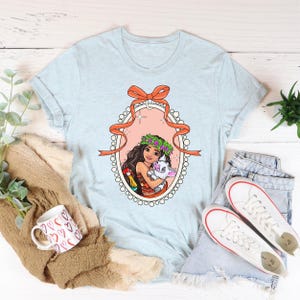 a t - shirt with a picture of a woman holding a cat