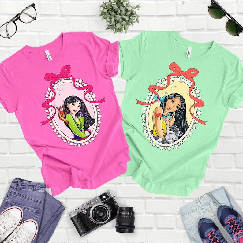 a couple of t - shirts sitting on top of a white brick wall