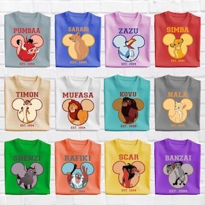 May include: A collection of twelve t-shirts in various colors, each featuring a character from The Lion King inside a Mickey Mouse ear silhouette. Names like Pumbaa, Simba, and Scar are printed above the graphics, with EST. 1994 or 1998 below.