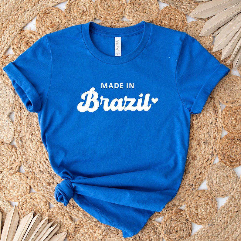 May include: A royal blue t-shirt with white text that reads "Made in Brazil" with a heart symbol.