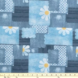 May include: A patchwork fabric design featuring denim-like squares and rectangles in various shades of blue. White daisies with yellow centers are scattered across the fabric. Some squares have a checkered pattern.
