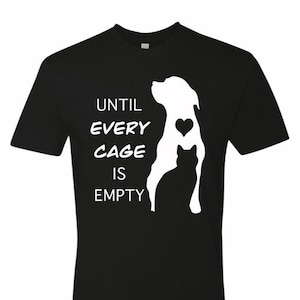May include: Black t-shirt with a white silhouette of a dog and cat with a heart in the dog's chest. The text "Until every cage is empty" is printed below the silhouettes.