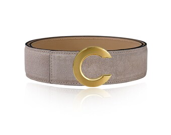 May include: A light gray suede belt with a gold-toned C-shaped buckle.
