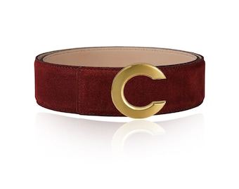 May include: A burgundy suede belt with a gold-toned C-shaped buckle.
