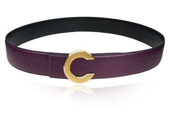 May include: A purple leather belt with a gold-toned C-shaped buckle.