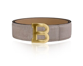 May include: A gray suede belt with a gold-tone buckle featuring a large letter "B".