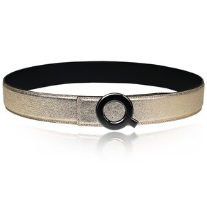 May include: A gold-colored leather belt with a black, letter Q-shaped buckle.