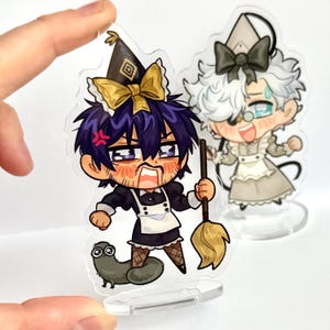 May include: Two acrylic charms depicting anime-style characters. One character is in a black maid outfit with a broom, the other in a grey maid outfit. The first has purple hair and an angry face, the second has white hair and a happy expression.
