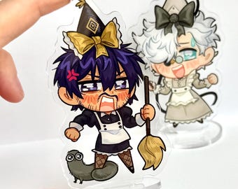 May include: Two acrylic charms featuring anime-style characters. One character is dressed in a black maid outfit with a broom, and the other in a gray maid outfit. The first character has purple hair and an angry expression, while the second has white hair and a happy expression.