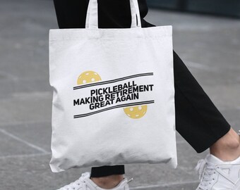 May include: White canvas tote bag with black text that reads "Pickleball Making Retirement Great Again" and two yellow pickleball images.