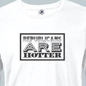 May include: White long-sleeve t-shirt with black text that reads "Republicans Are Hotter" in a bold, blocky font.