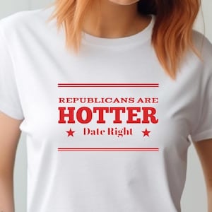 May include: White t-shirt with red text that reads "Republicans are Hotter Date Right" with a red star on either side of the text.