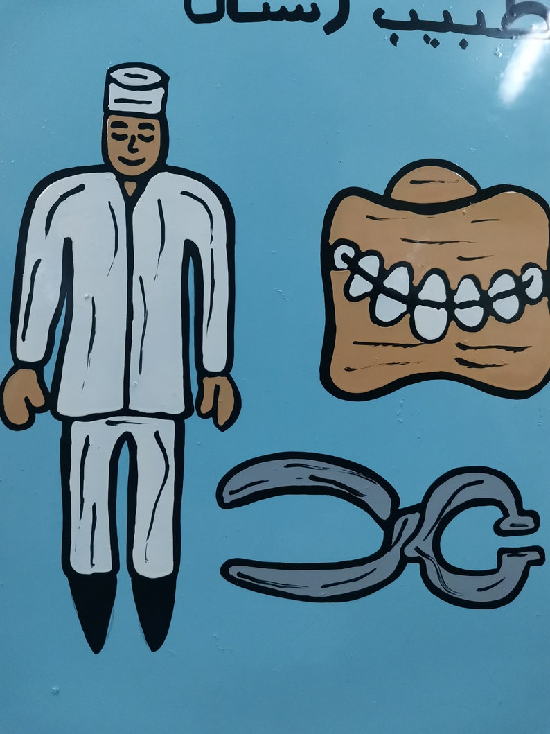May include: A cartoon illustration of a dentist with a white coat and a pair of pliers. The dentist is standing next to a set of teeth. The background is blue.