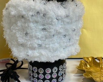 A Black Table Lamp with white fur and gemstones.