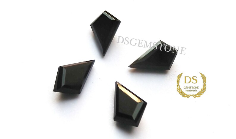 May include: Four black kite-shaped gemstones with faceted surfaces arranged in a cluster. The text DSGEMSTONE is visible in the upper right, and a gold logo with the letters DS and the word GEMSTONE Handmade is in the lower right corner.