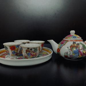 Vintage porcelain tea pot set with miniature cups