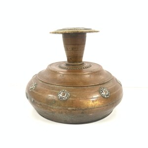 May include: A brown metal vase with a round base and a cylindrical neck. The vase is decorated with silver-colored metal accents.