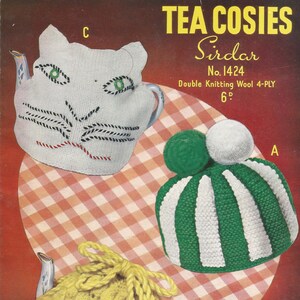 May include: Three knitted tea cozy patterns: a white cat-shaped cozy, a green and white striped cozy with white pom-poms, and a yellow cozy with a bow. The pattern is called "Sirdar No. 1424" and is made with double knitting wool.