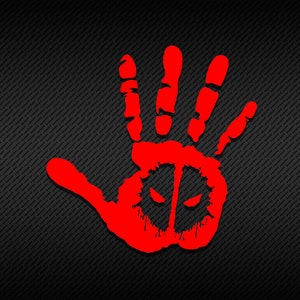 May include: A red handprint with a black mask design inside. The handprint is on a black background with a diagonal line pattern.