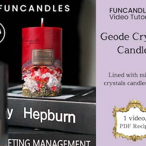 May include: A red geode crystal candle with gold accents and clear and red crystals. The candle is on a black book with the word "Hepburn" on the cover. The text "FUNCANDLESTM Video Tutorials" and "Geode Crystal Candle" is in the upper right corner of the image. The text "Lined with mineral crystals candlesnium" is below the candle name. The text "1 video, PDF Recipe" is in a gold frame in the lower right corner of the image.