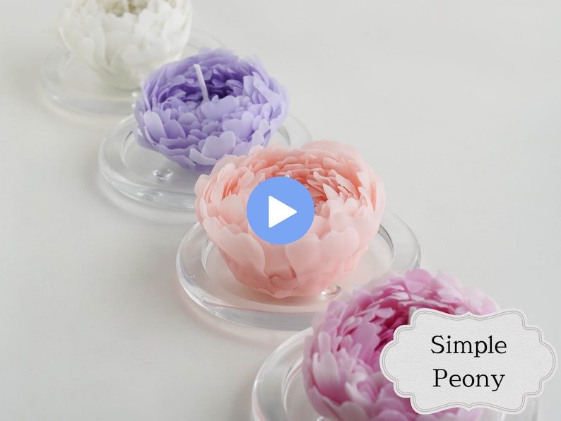May include: Four simple peony candles in white, lavender, pink, and magenta. The candles are arranged in a row on clear glass bases. The text "Simple Peony" is visible in the lower right corner of the image.