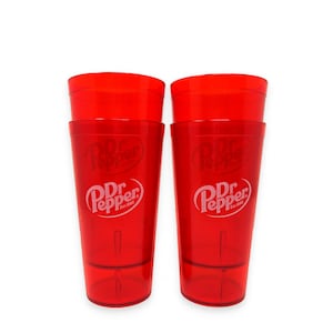 May include: Two translucent red plastic tumblers featuring the white Dr Pepper logo and the text Est. 1885 printed on the front. Each cup has a tapered cylindrical shape with a smooth finish and a slightly thicker base for stability and durability.