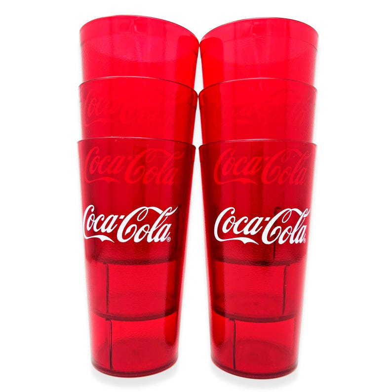 May include: A stack of eight red plastic Coca-Cola glasses. Each glass has the Coca-Cola logo in white. The glasses are transparent and appear to be empty, with a simple, classic design.
