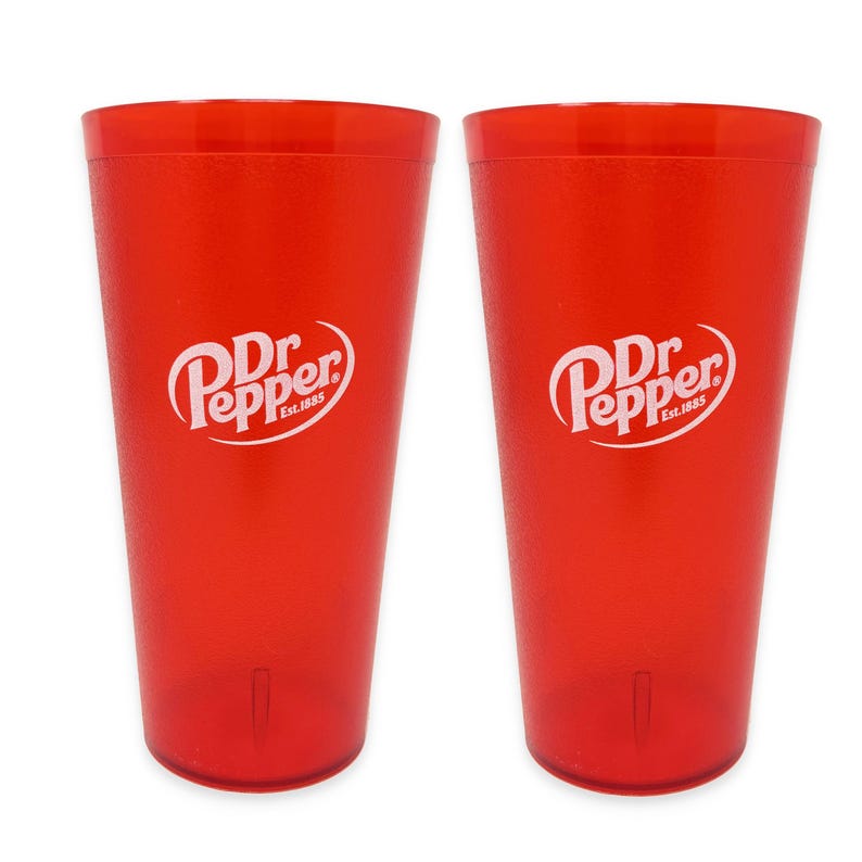 May include: Two identical translucent red plastic tumblers, each featuring the white Dr Pepper logo with the text Est. 1885 printed on the front. These tall, cylindrical drinking cups have a smooth finish and a slightly tapered base design.