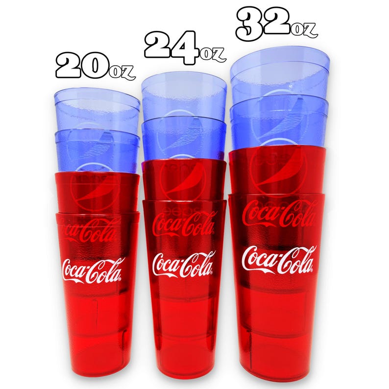 May include: A stack of Coca-Cola branded plastic cups in red and blue. The cups are in three sizes: 20oz, 24oz, and 32oz. The red cups have the Coca-Cola logo in white. The blue cups are clear.