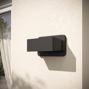 May include: A black rectangular wall-mounted light fixture with a modern design.