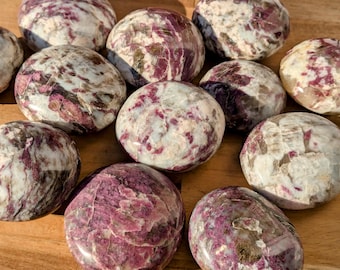 May include: A collection of 10 tumbled pink and white stones with a variety of patterns. The stones are smooth and polished, and they have a natural, organic look.