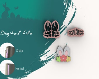 May include: Three pink plastic cookie cutters shaped like bunny ears with flowers, a row of flowers, and a bunny with flowers. The cutters are on a white background.