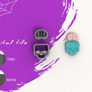 May include: A digital file for a 3D printed cookie cutter set. The set includes a skull cookie cutter and a brain cookie cutter. The skull cookie cutter is gray and the brain cookie cutter is pink. The text "Digital file" is visible in the image.