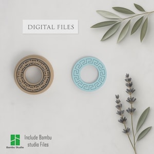 May include: Two circular objects with a Greek key design, one tan and one light blue, are displayed. The text "DIGITAL FILES" is above them. The image also includes text that says "Include Bambu studio Files" and the Bambu Studio logo.