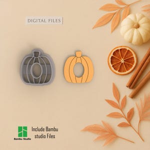 May include: Two pumpkin-shaped cookie cutters, one gray and one orange, next to a small white pumpkin, dried orange slice, and cinnamon sticks. The text "DIGITAL FILES" is above the cutters. The text "Include Bambu studio Files" is below the cutters.