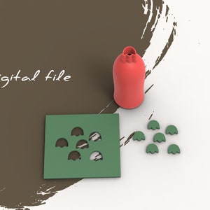 以下が含まれることがあります： 赤いボトルと緑の葉を持つ3Dプリントモールドのデジタルファイル。このモールドは、複数の葉を作成するために設計されています。